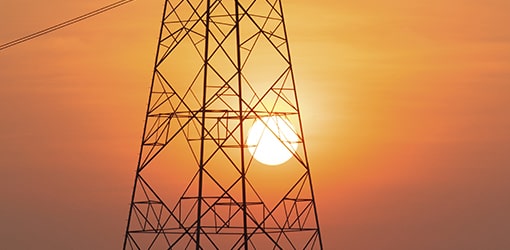 A part of the electric pole against orange sky