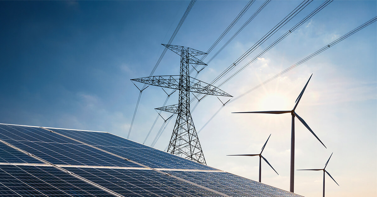 An electric power line, solar panels, and wind turbines against a bright blue sky.