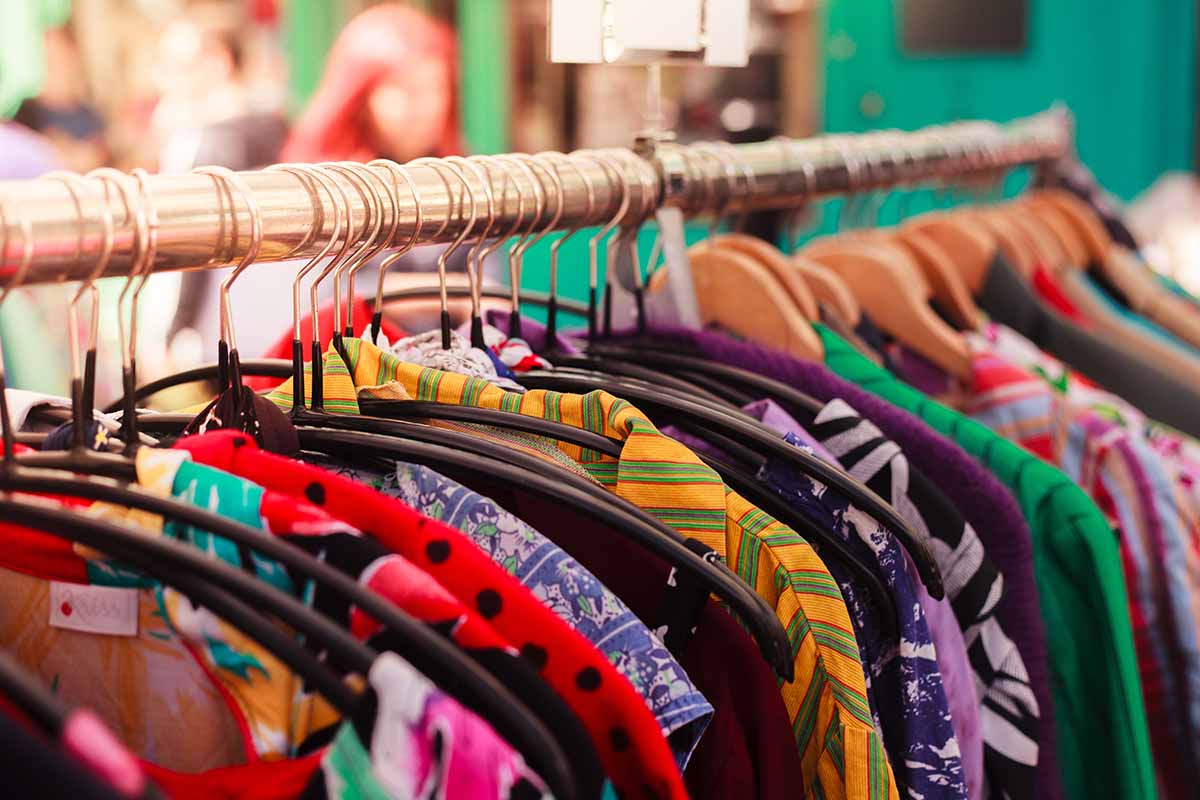 Clothes on a sleigh hanging in hangers.