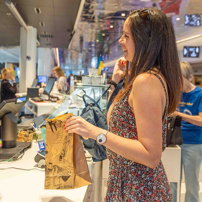 A customer orders food at food counter in Tampere Hall.