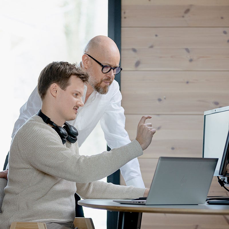 Solteq's project managers at work desk