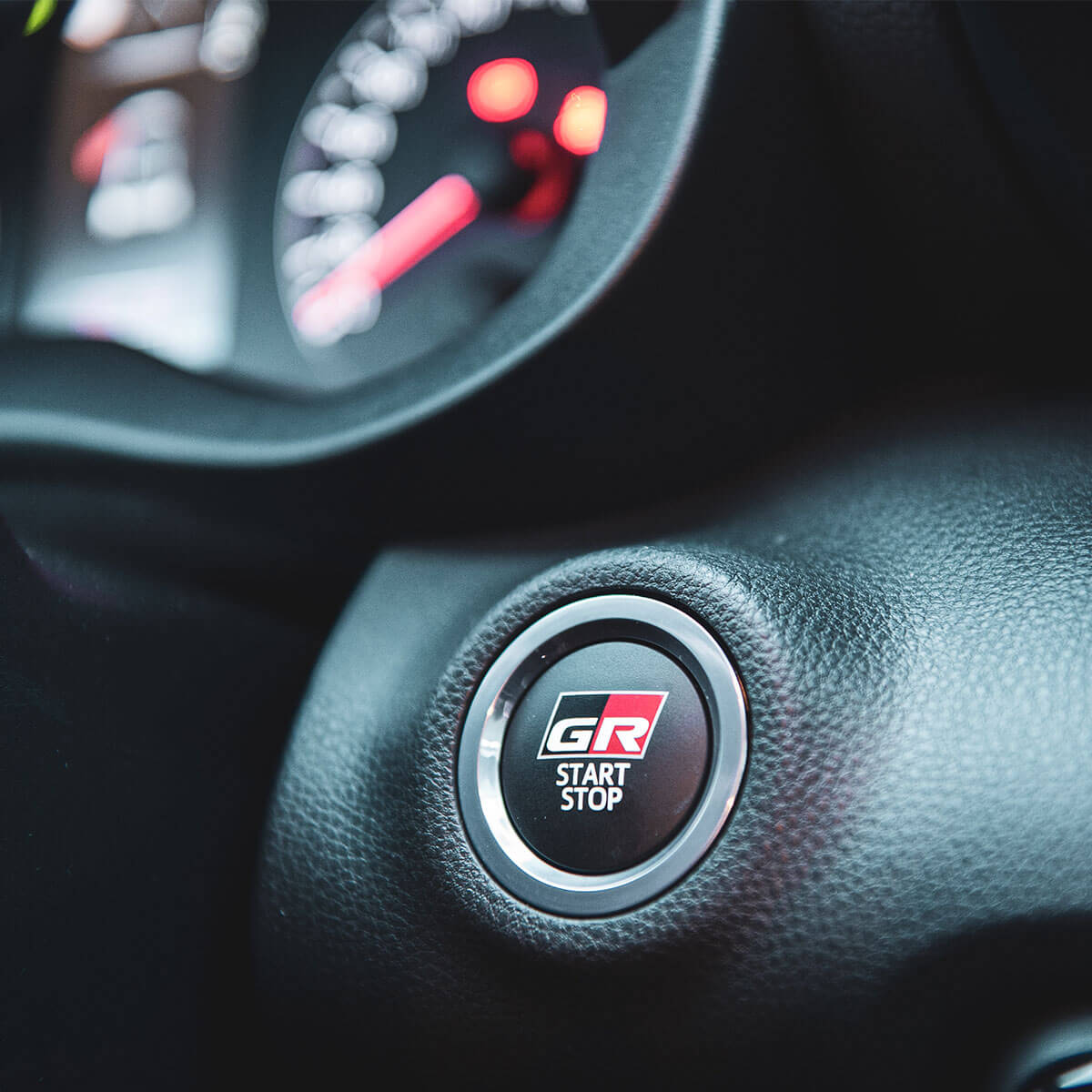 Close-up of a car's start/stop button