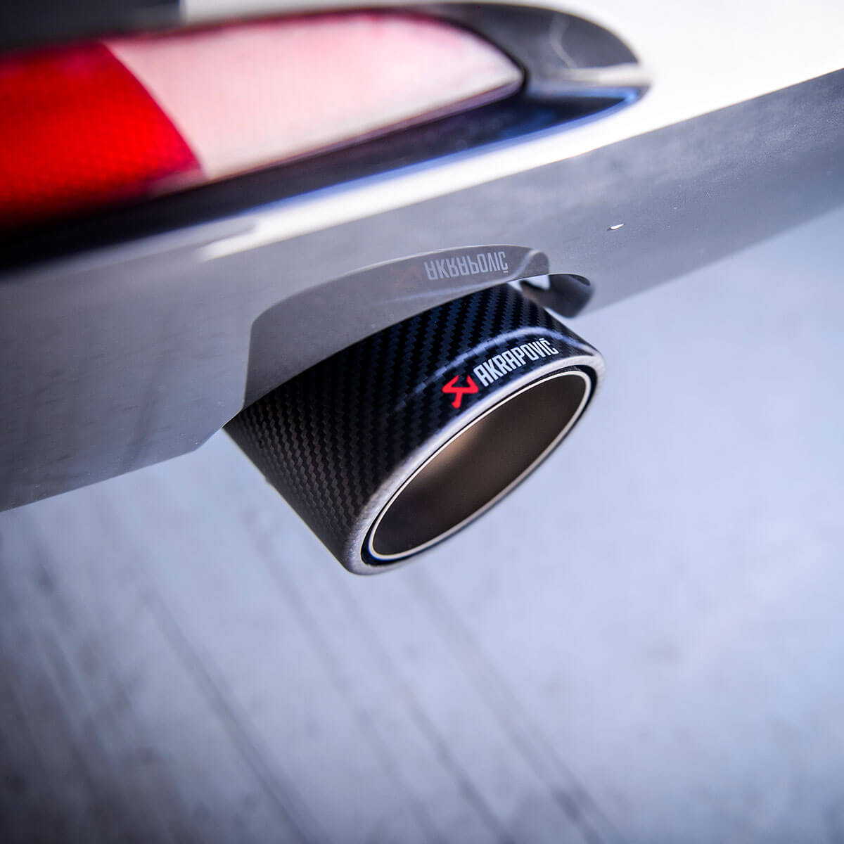Close-up of the carbon fiber-finished exhaust tip made by Akrapovic