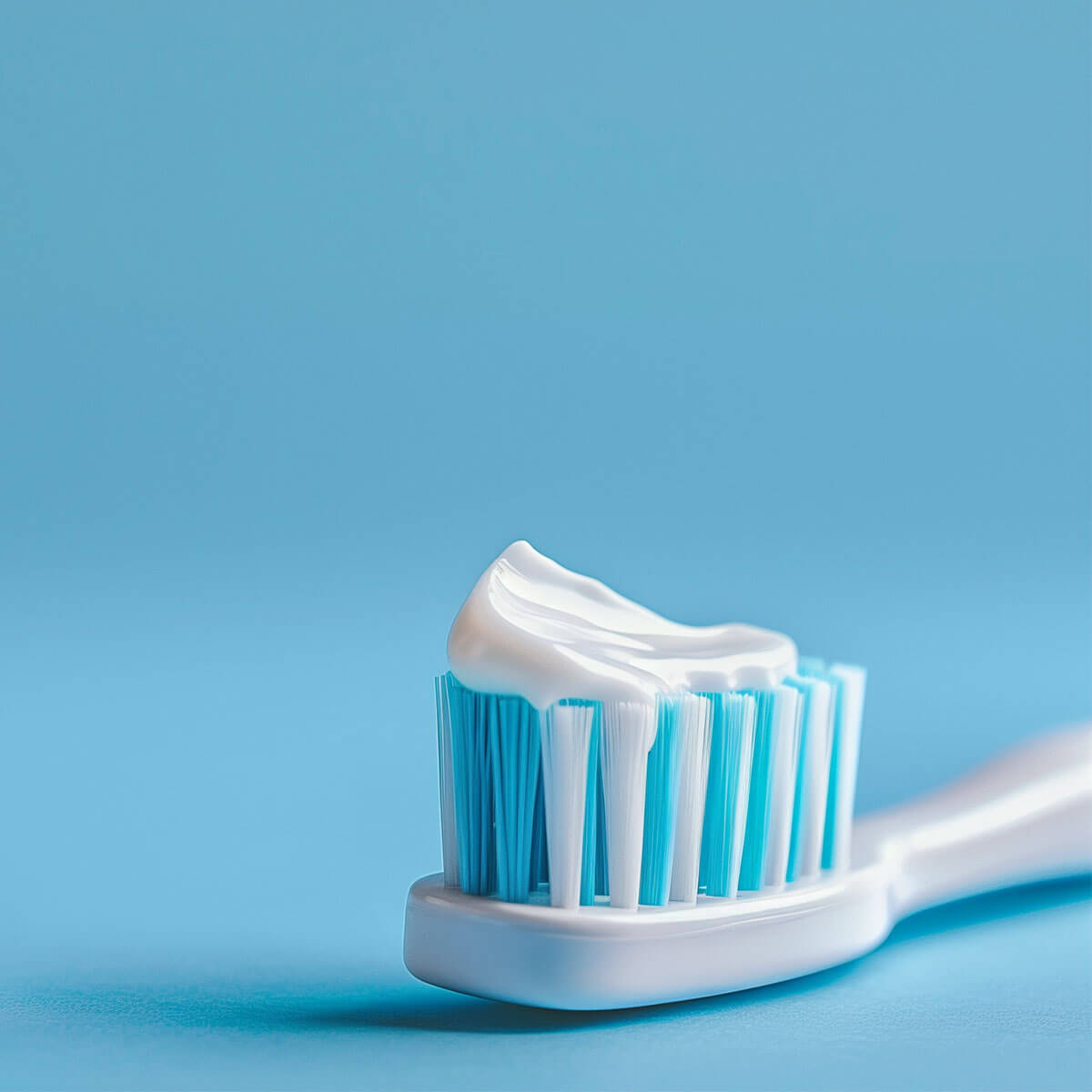 Nærbillede af tandbørste med tandpasta ovenpå