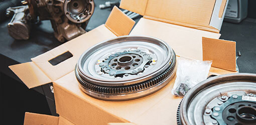 Dual mass flywheels sold online await packaging on a cardboard box