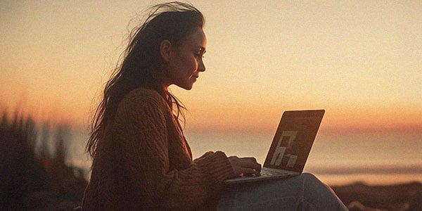 Woman reviewing personalization workshop results with her laptop, calm horizon in the background