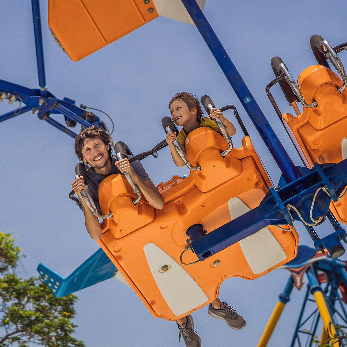Father and son in an amusement park roller coaster ride