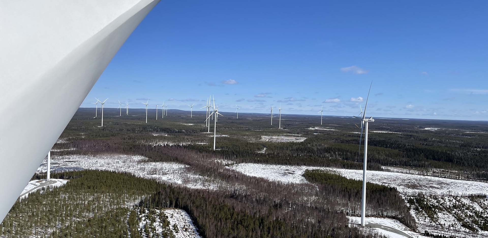 Tuuliturbiinin yläosasta avautuva talvinen metsämaisema - kuvaaja Antti Polet