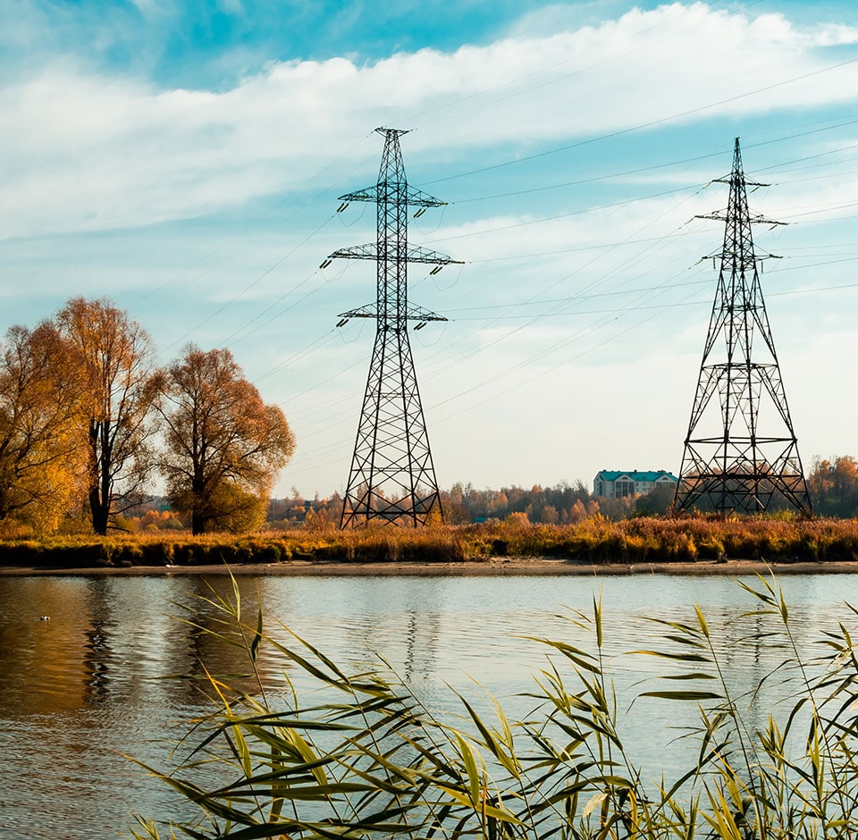 Power lines near lake in autumn.