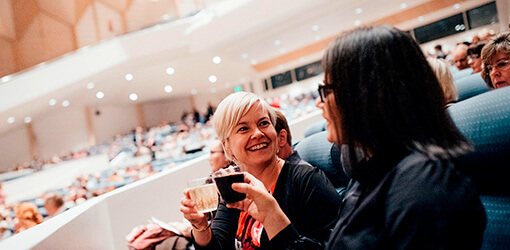 Smiling customers enjoying Tampere Hall's event.