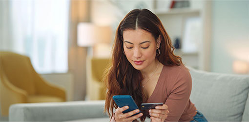 Woman making e-commerce payment via mobile