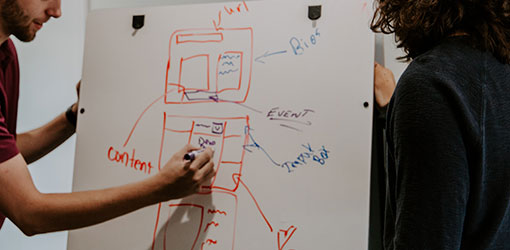 An SEO expert designs technical search engine optimization on  a whiteboard