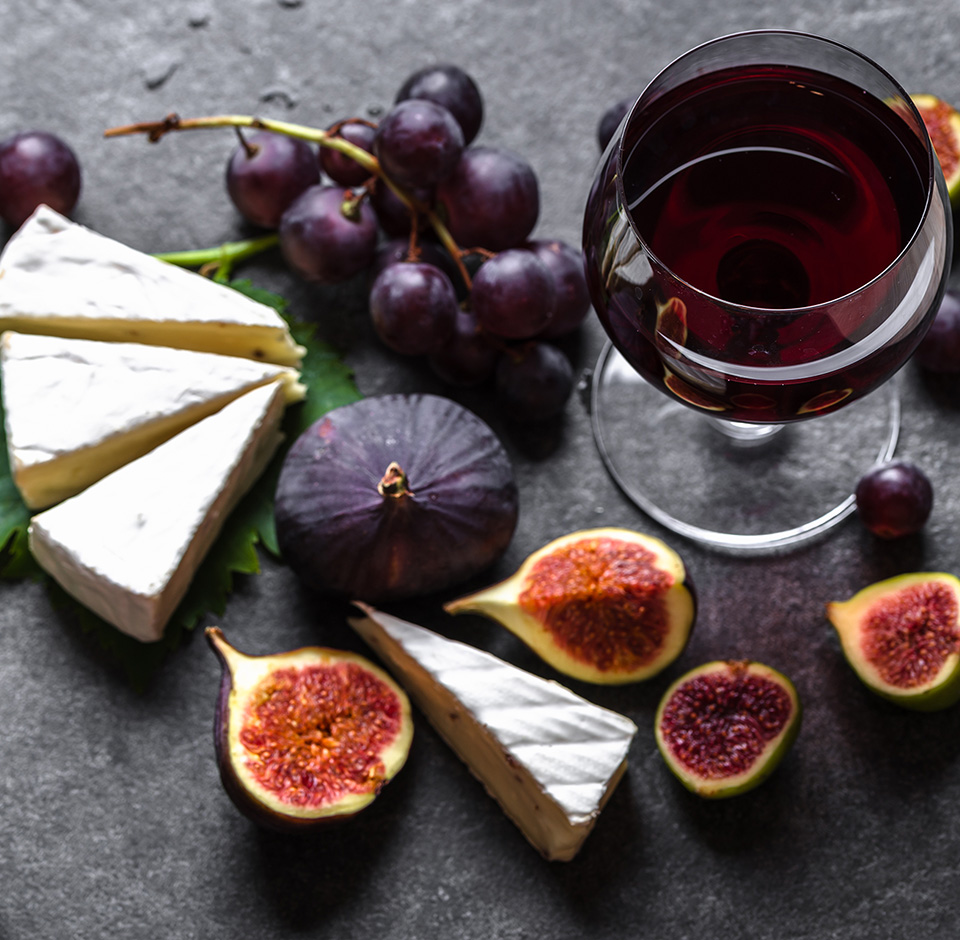 Cheese, wine and figs on the table.