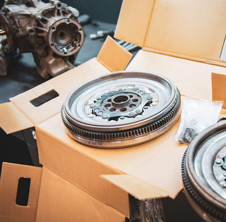 Dual mass flywheels sold online await packaging on a cardboard box
