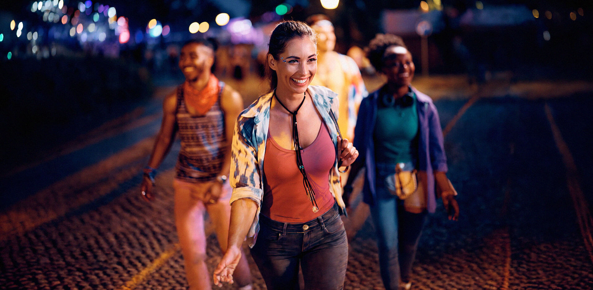 Event attendees walking through a venue at night, representing seamless guest experiences supported by modern POS and ticketing systems