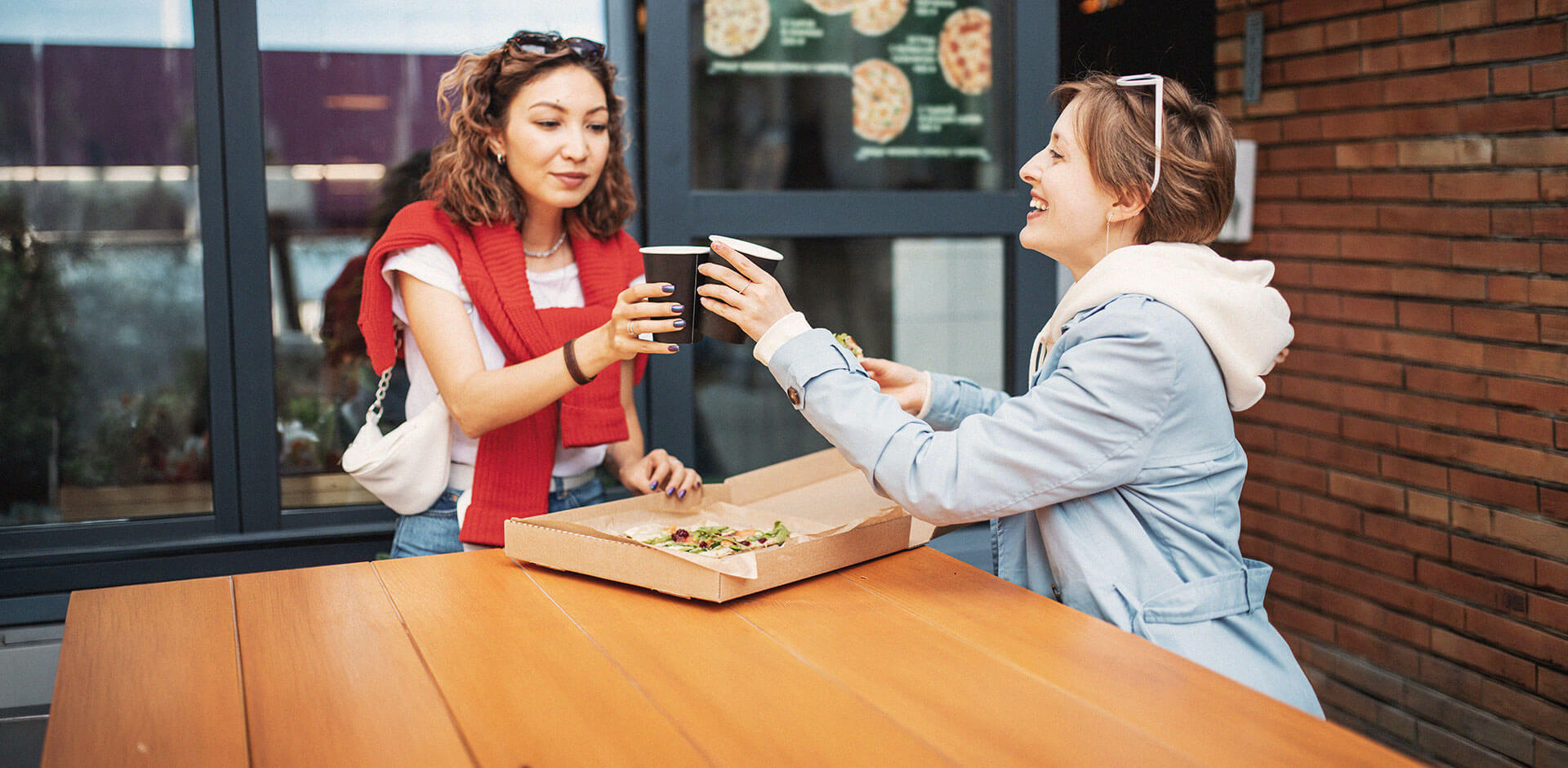 Customers enjoying food and drinks after ordering, representing smooth self-service kiosk experiences in a modern hospitality environment