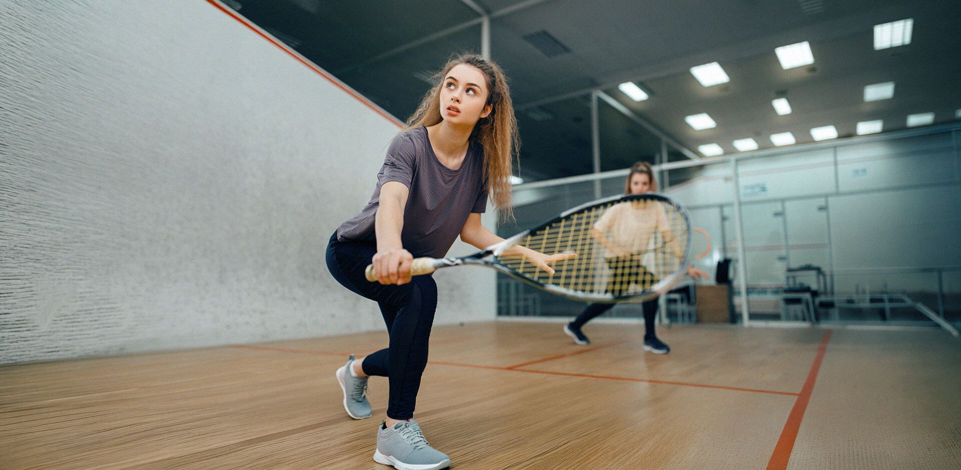 Players competing in an indoor sports venue, representing efficient venue operations supported by modern POS and booking systems