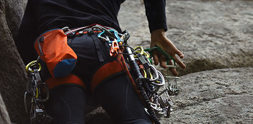 Mountain climber climbing rocky mountain