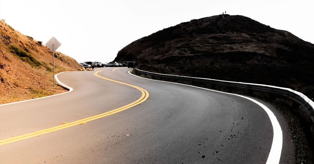 The winding road rises up in the mountains.