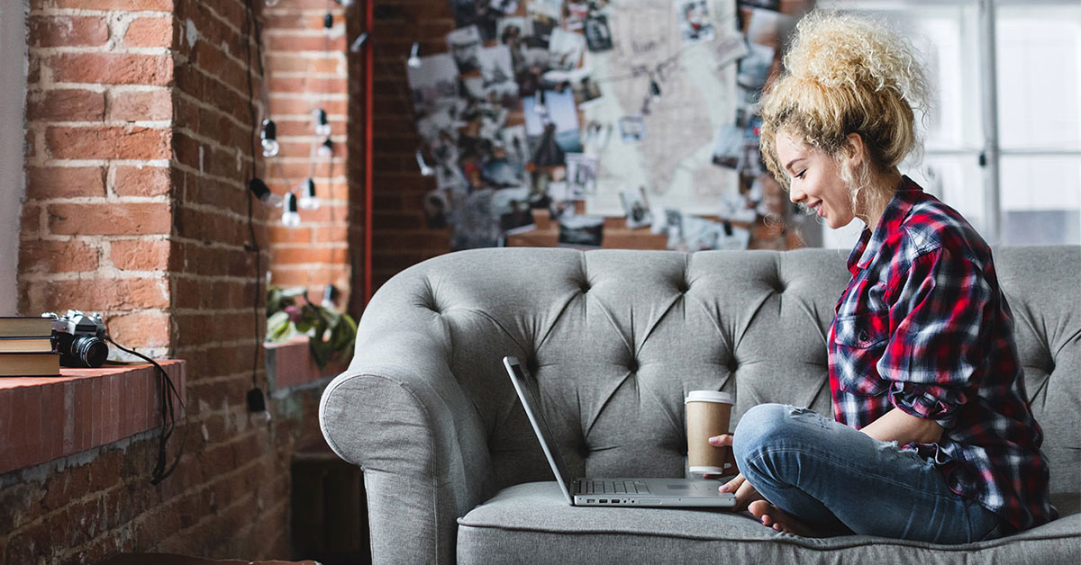 Women sitting on a couch and doing online shopping.