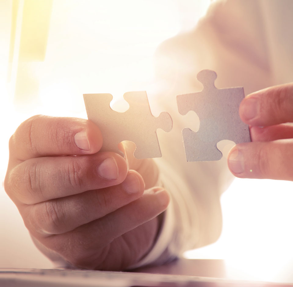 A man putting together ERP puzzle pieces