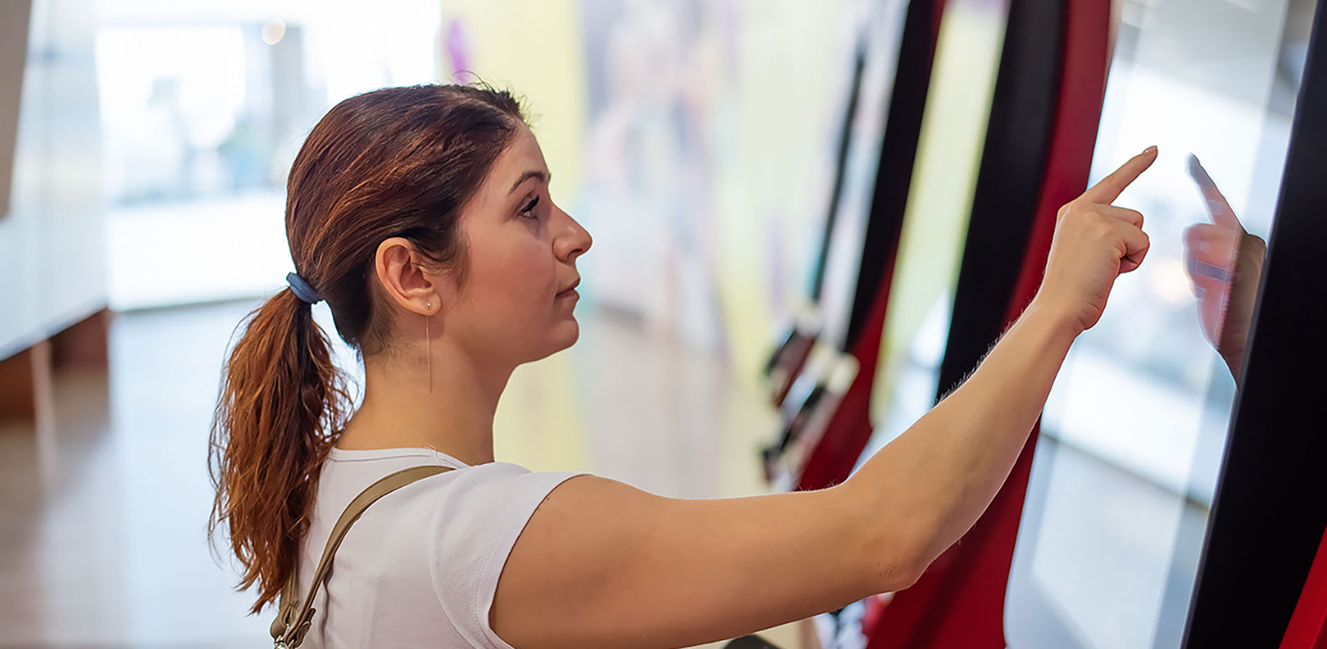 A customer using self-service checkout in a store.