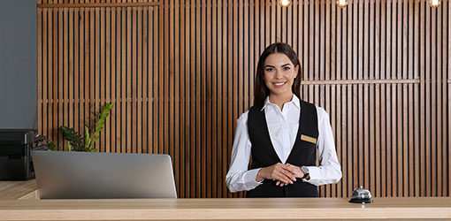 Smiling hotel receptionist welcoming guests