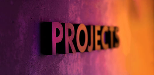 Projects word on wall with purple and orange background.