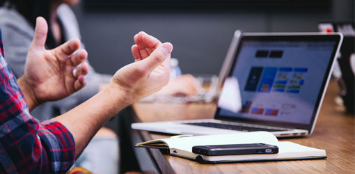 ERP - Man and woman in a meeting about ERP solution with laptop on table