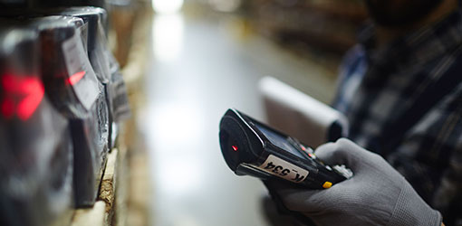 Order Engine - Barcode scanner reading product information in a warehouse